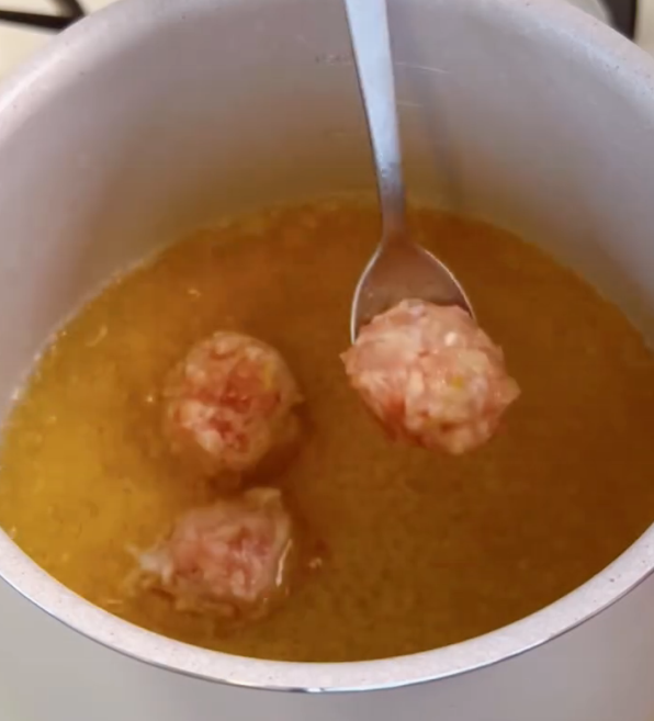 Step 2.1: Gently drop the chicken meatballs into the boiling dashi stock