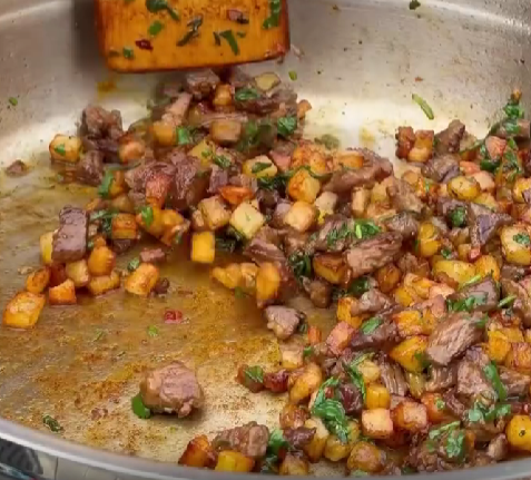Step 1.1: Add the cooked potatoes back to the pan along with paprika, chili flakes, garlic, and fresh coriander