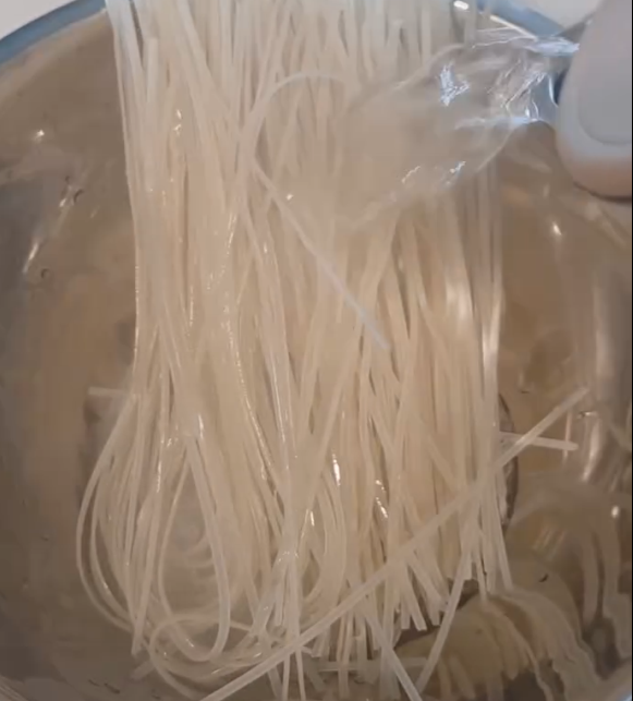 Step 2.1: Place the rice noodles into a large bowl and cover with boiling water