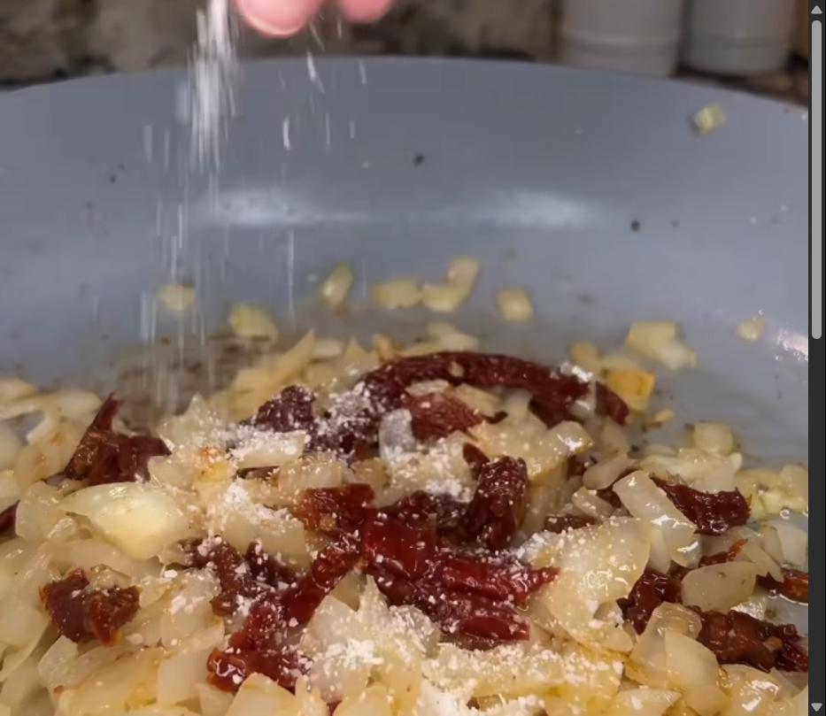 Step 1.1: Add sun dried tomatoes to the pan along with basil, parsley, oregano, red pepper flakes, salt, and pepper, then stir and cook for 1 minute
