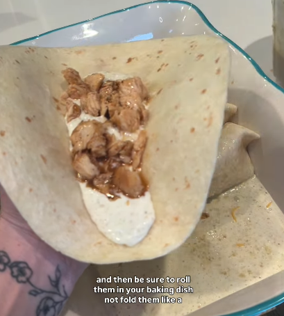 Step 1.1: Assemble the enchiladas by filling the tortillas with the marinated chicken and shredded cheese, then rolling them up and placing them in the baking dish