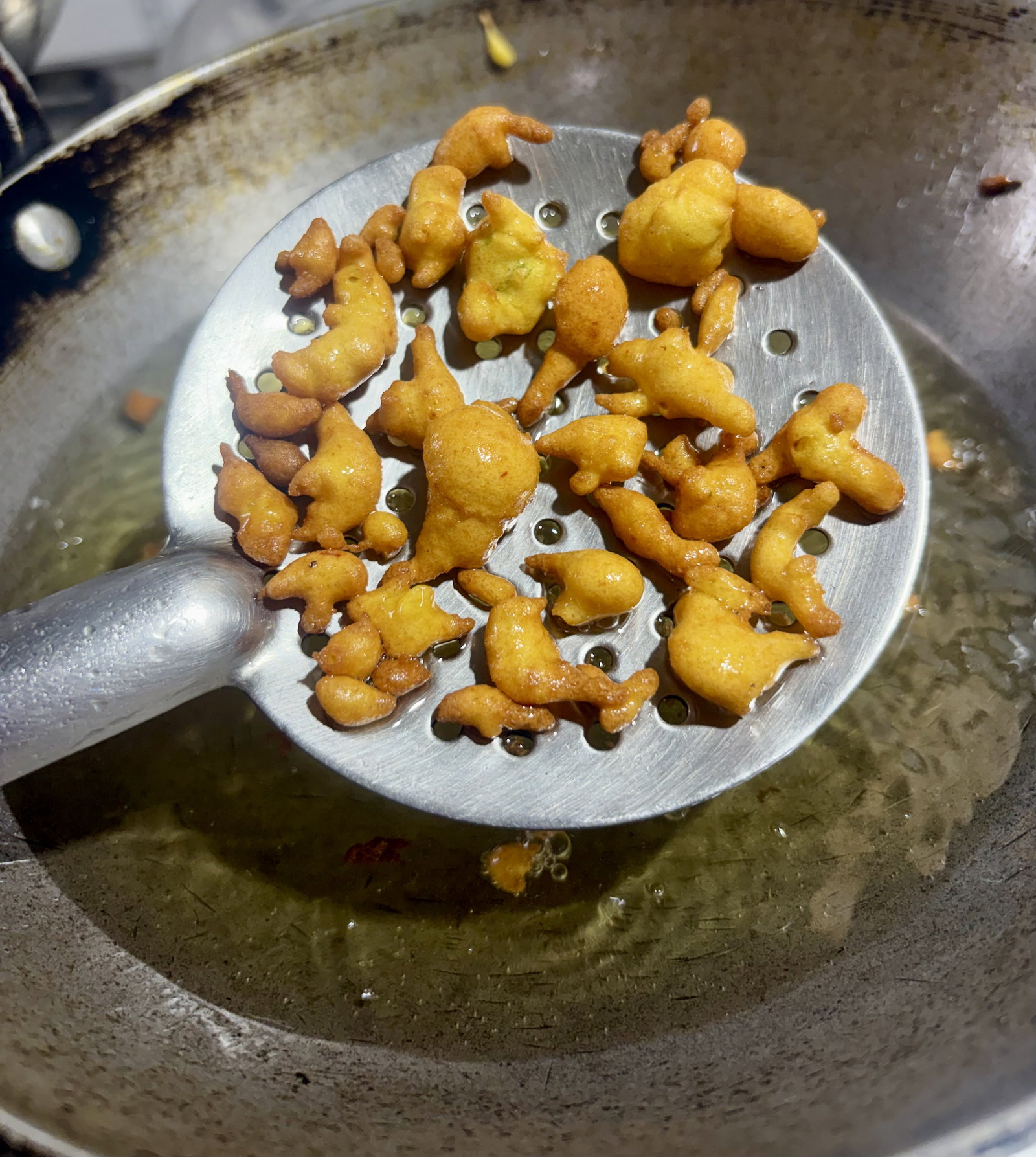 Step 3.2: Using leftover batter, drip small spoonfuls into the oil to form tiny drops