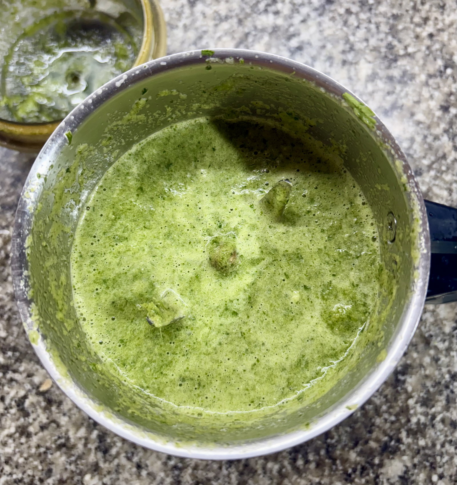 Step 2.2: Blend the garlic, ginger, green chillies, coriander leaves, and ½ cup water into a smooth green paste