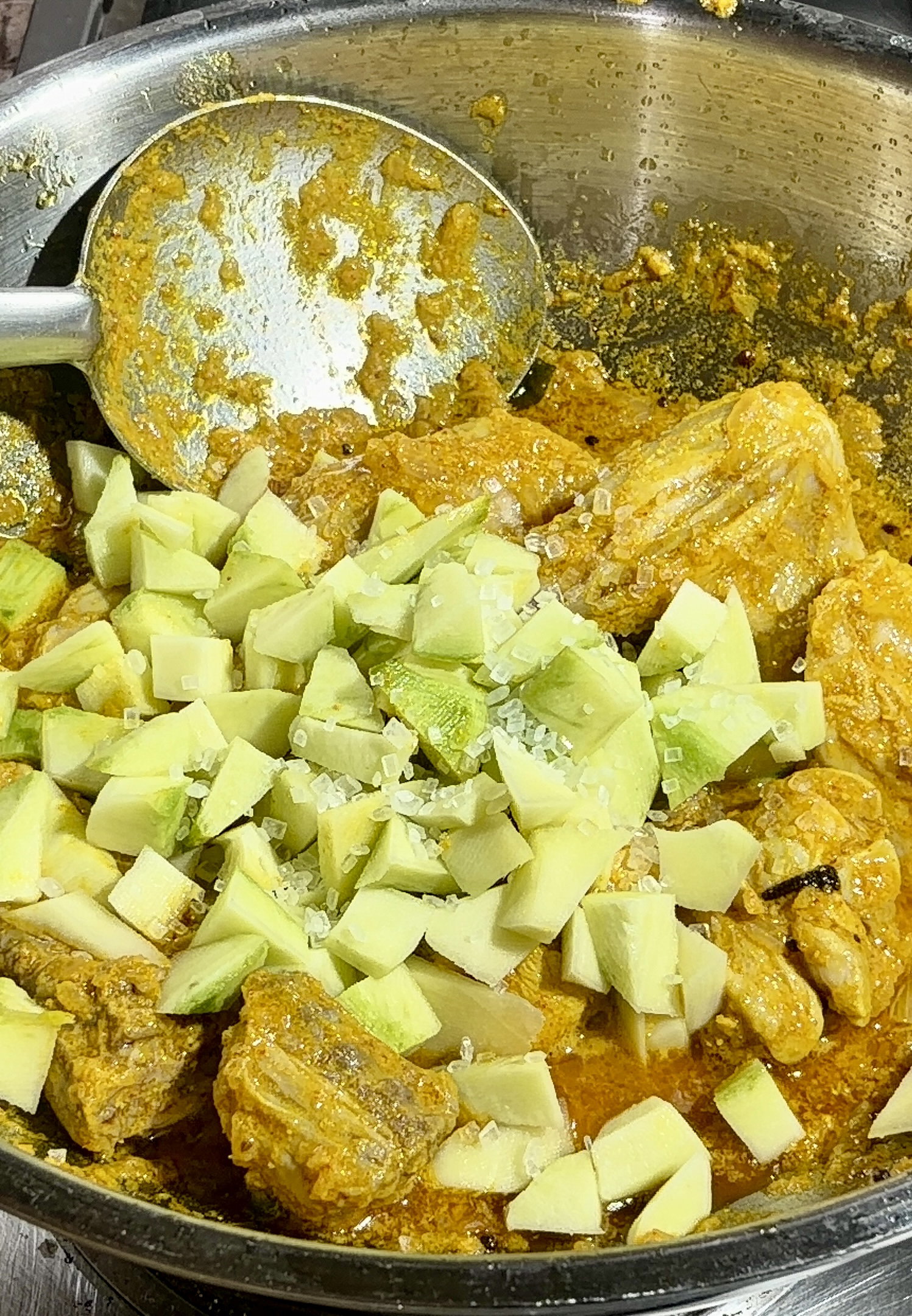 Step 4.1: Stir in the raw mango pieces and sugar