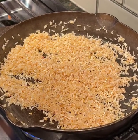 Step 2.1: Add rice and toast for 1–2 minutes to enhance flavor