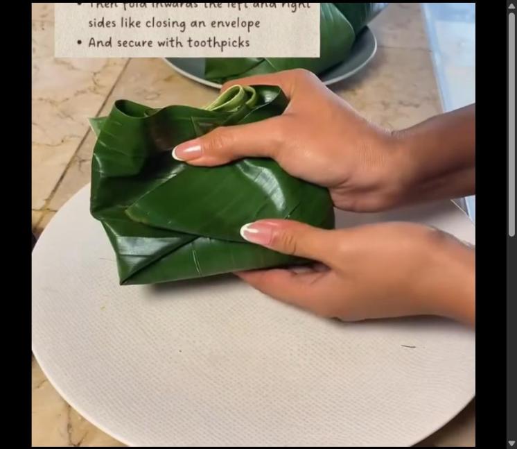 Step 4.1: Fold the bottom part of the leaf up over the filling, then fold inwards the left and right sides like closing an envelope, and secure with toothpicks