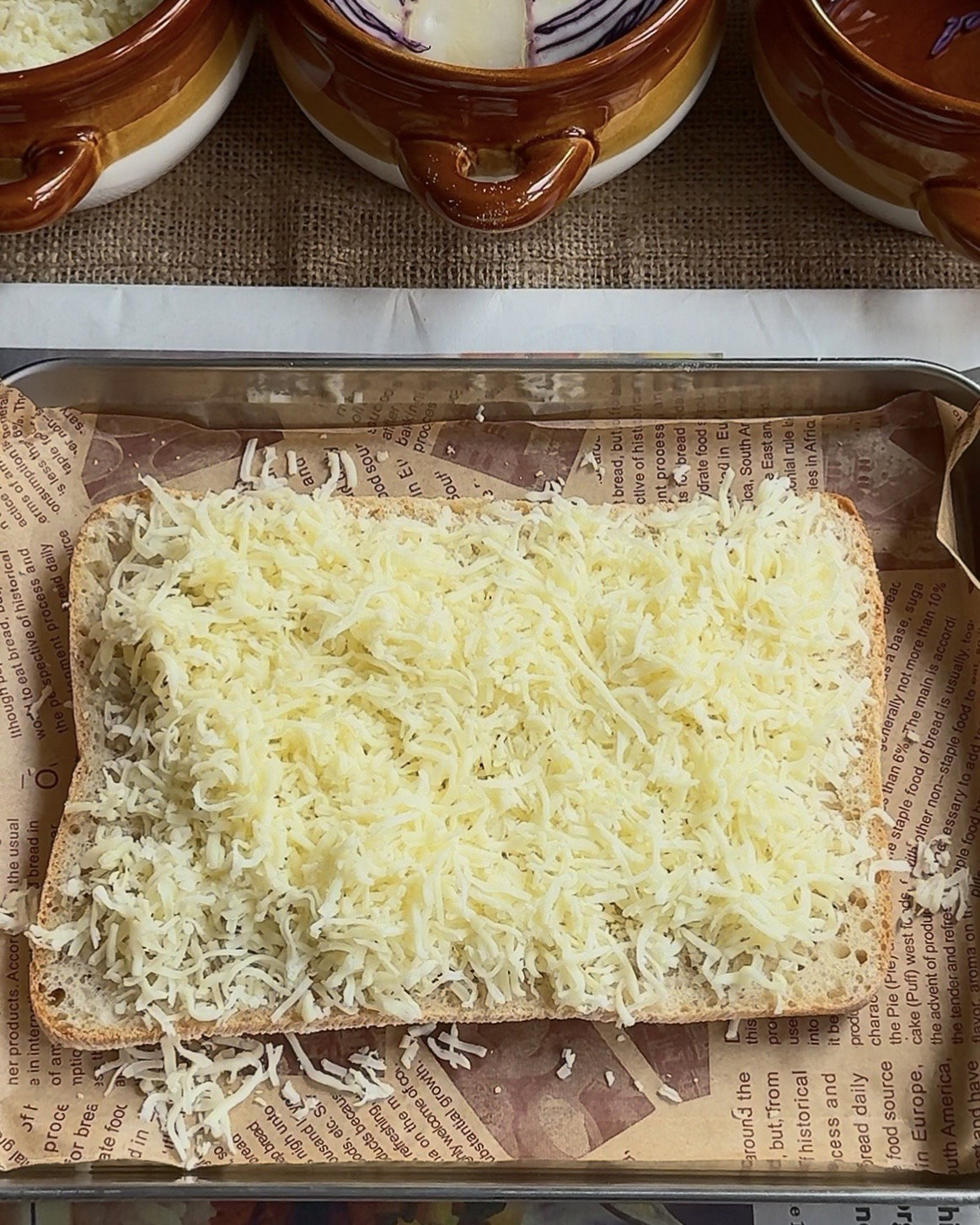 Step 3.1: Add a generous amount of grated mozzarella to both halves of the bread
