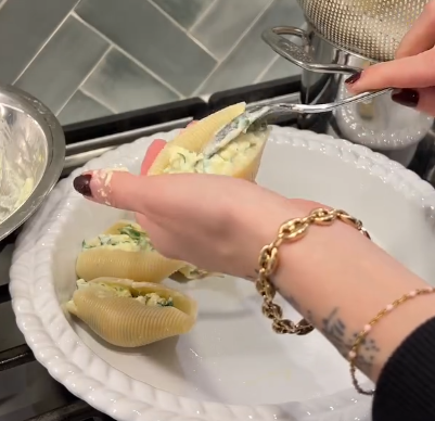 Step 4.1: Fill each cooked pasta shell with the ricotta mixture and place them in a baking dish
