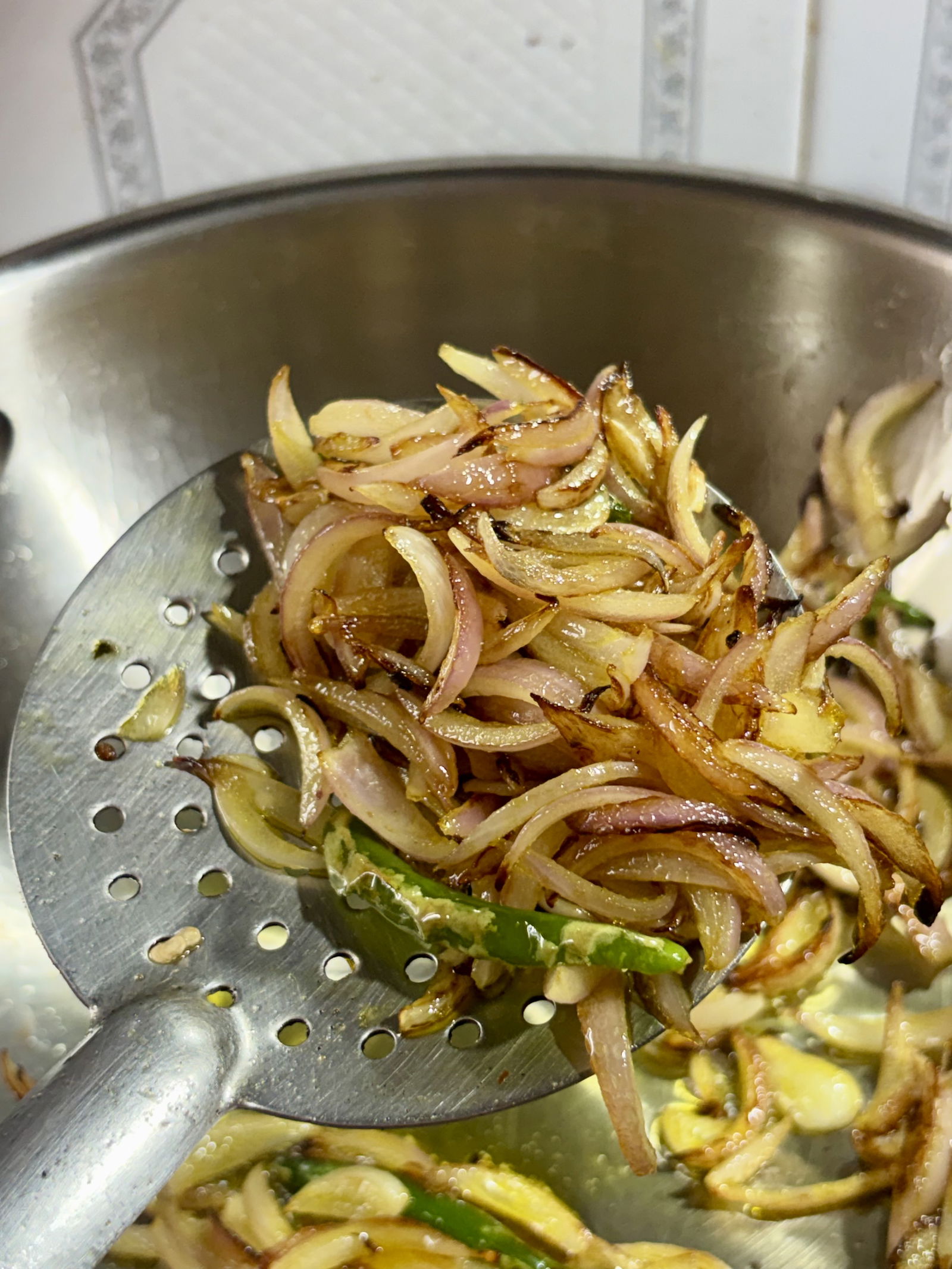 Step 3.2: Add the sliced onions and green chillies