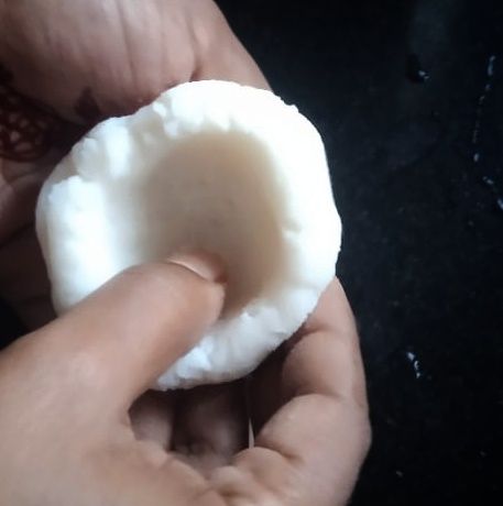 Step 2.2: Take one ball and press into the center with your thumb to make a bowl shape