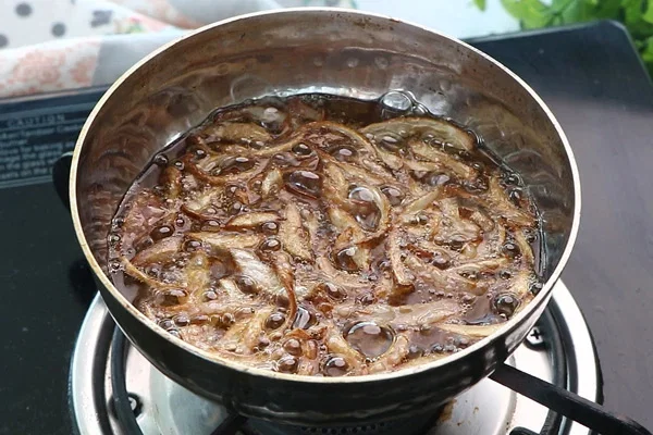 Step 2.1: Add the sliced onions and fry until they turn golden brown