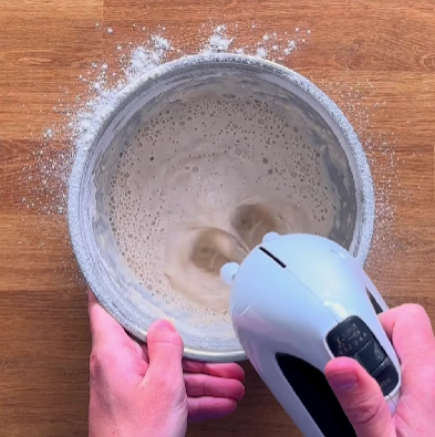 Step 1.1: Add the milk and the activated yeast/water mixture to the dry ingredients, then whisk for 5 minutes until smooth