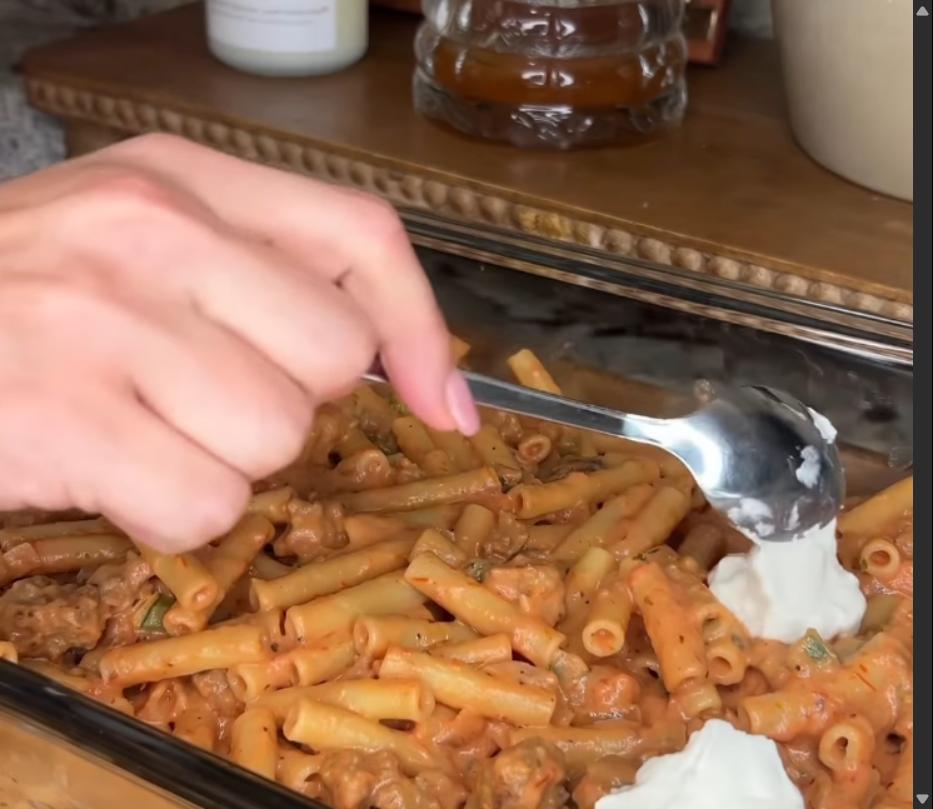 Step 1.1: Add ricotta cheese in spoonfuls over the noodle mixture, then top with the remaining noodle mixture