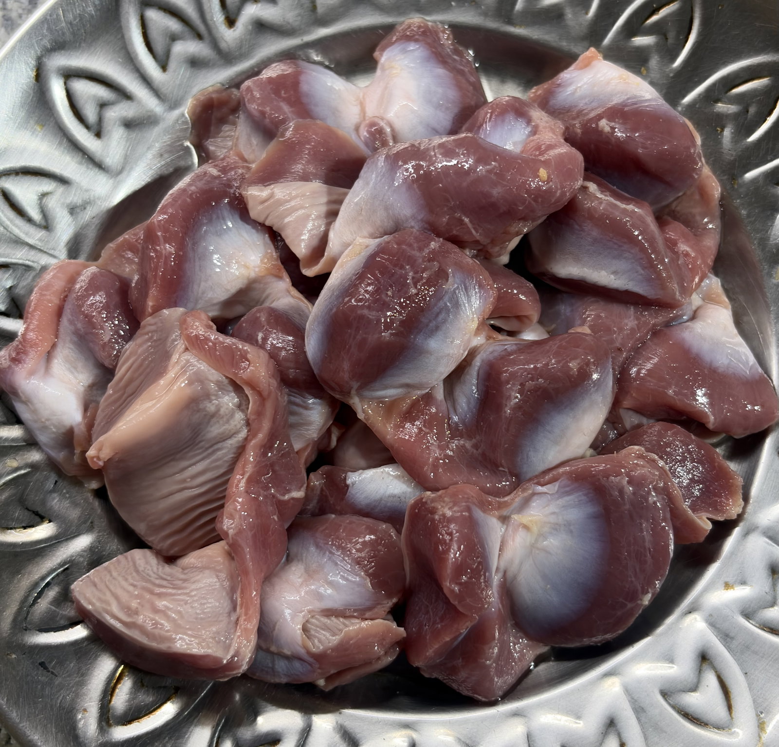Step 1.1: Wash the chicken gizzards thoroughly and cut them into halves or smaller pieces
