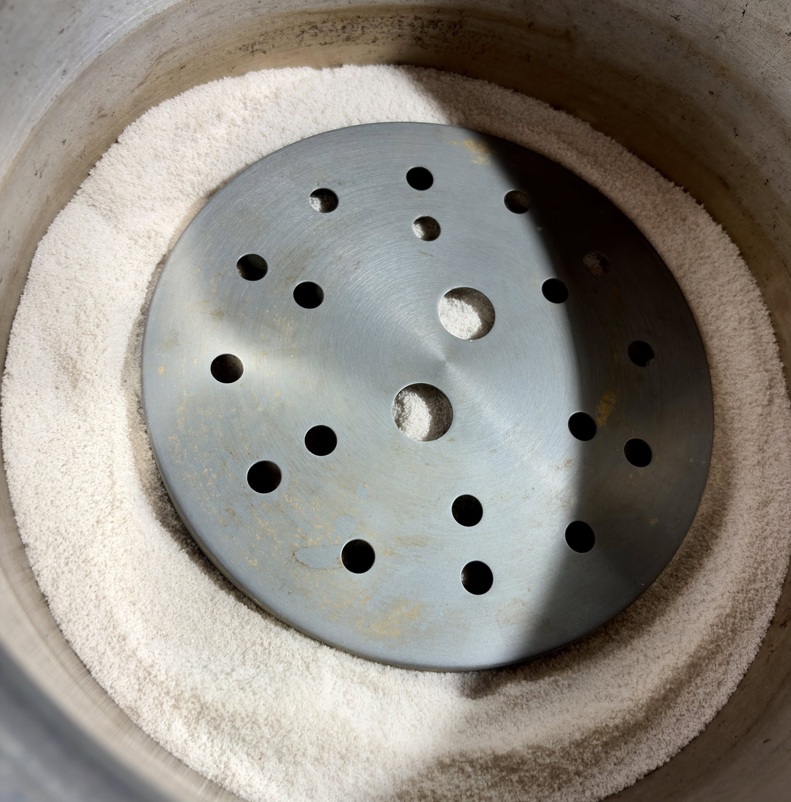 Step 1.1: Spread an even layer of salt inside a large heavy pot, place a metal stand inside, cover, and preheat on low for 10 minutes