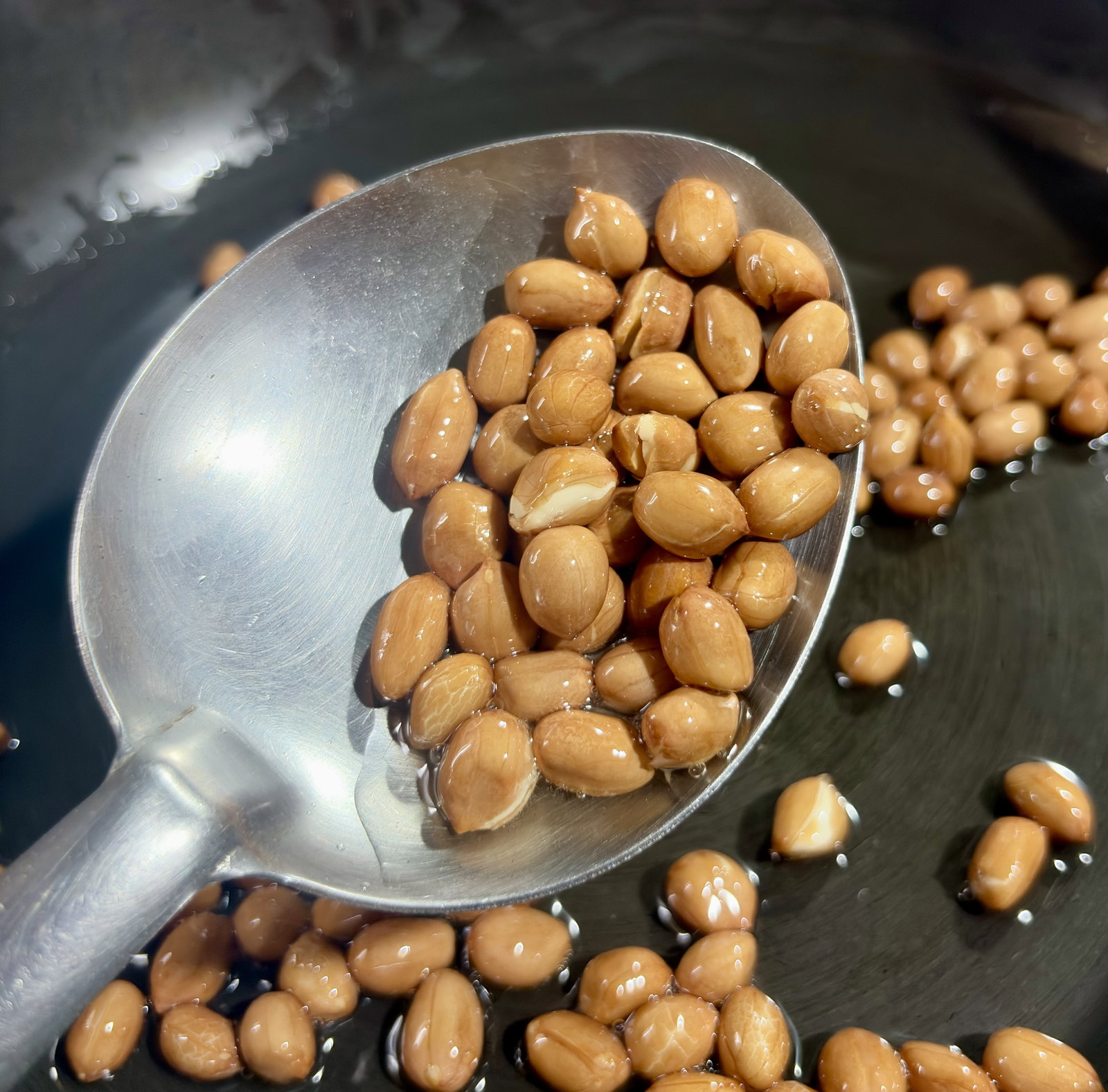 Step 2.1: Add the peanuts and fry until they turn golden and begin to crackle, about 3-4 minutes