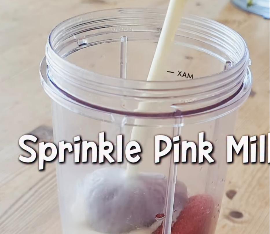 Step 1.1: Add frozen strawberries to a blender and add milk of choice