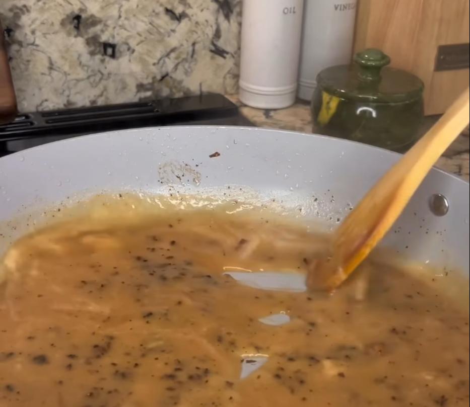 Step 3.1: Pour in beef broth, scraping brown bits off the bottom of the pan