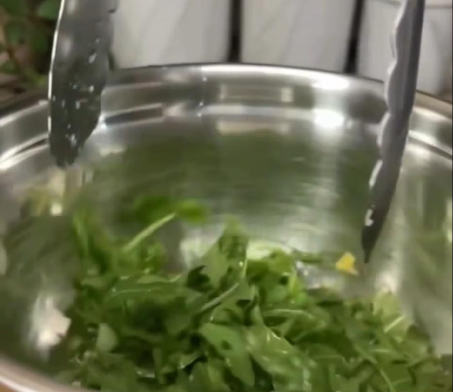 Step 2.1: Combine arugula with olive oil and a pinch of salt in a bowl, then toss to coat