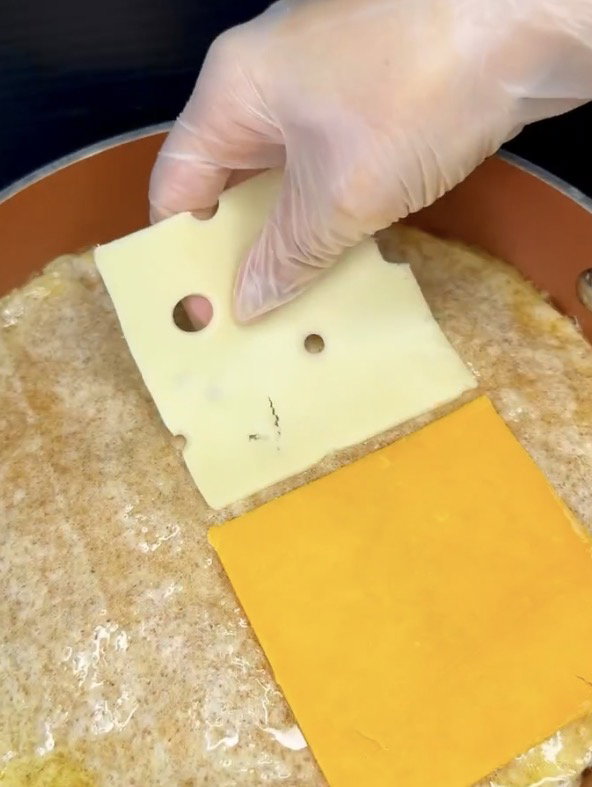 Step 1.1: Place cheddar and white American cheese slices on one half of the tortilla