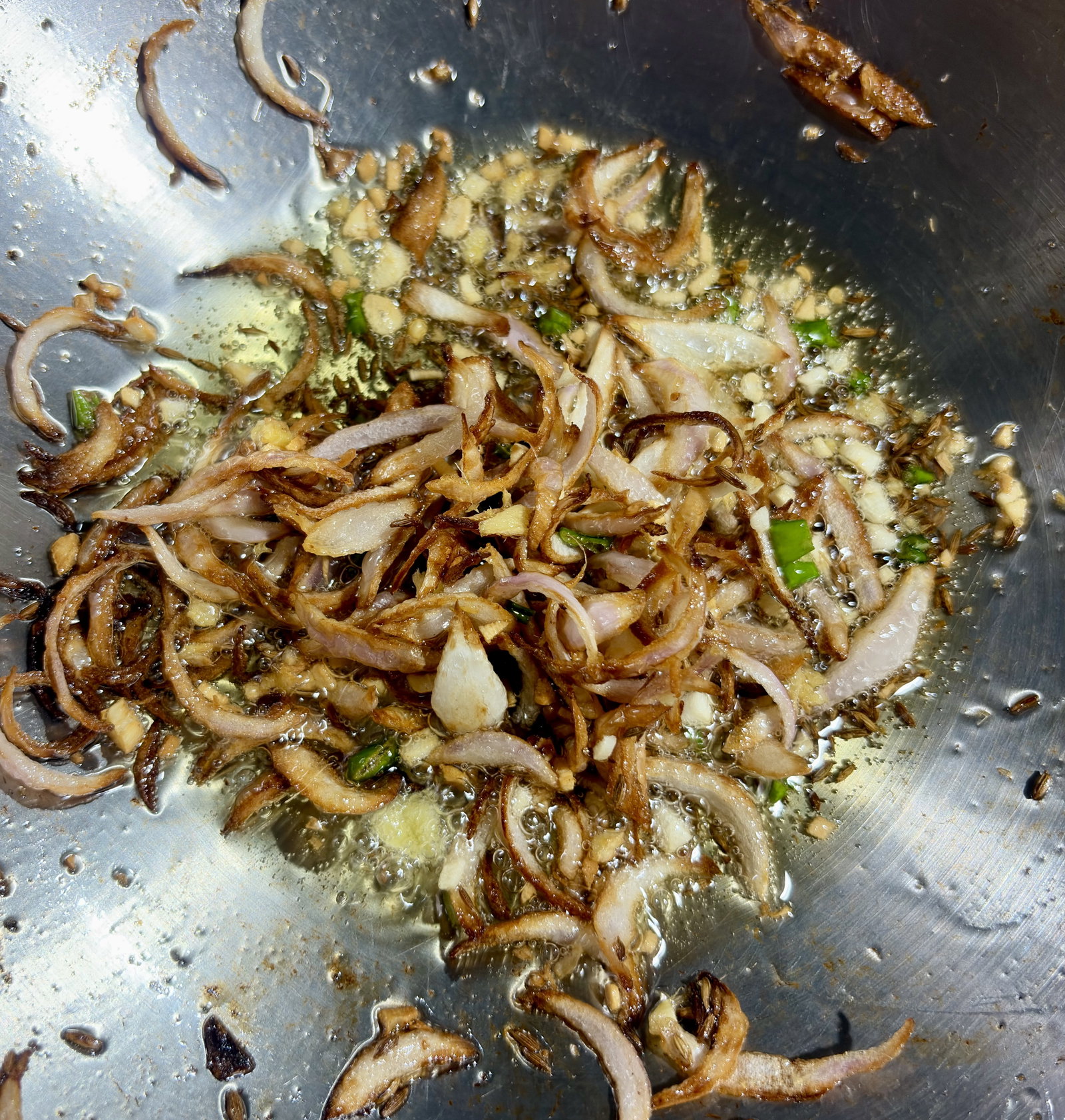Step 2.2: Stir in the chopped ginger, garlic, and green chilli, cooking for 1–2 minutes until the raw aroma disappears