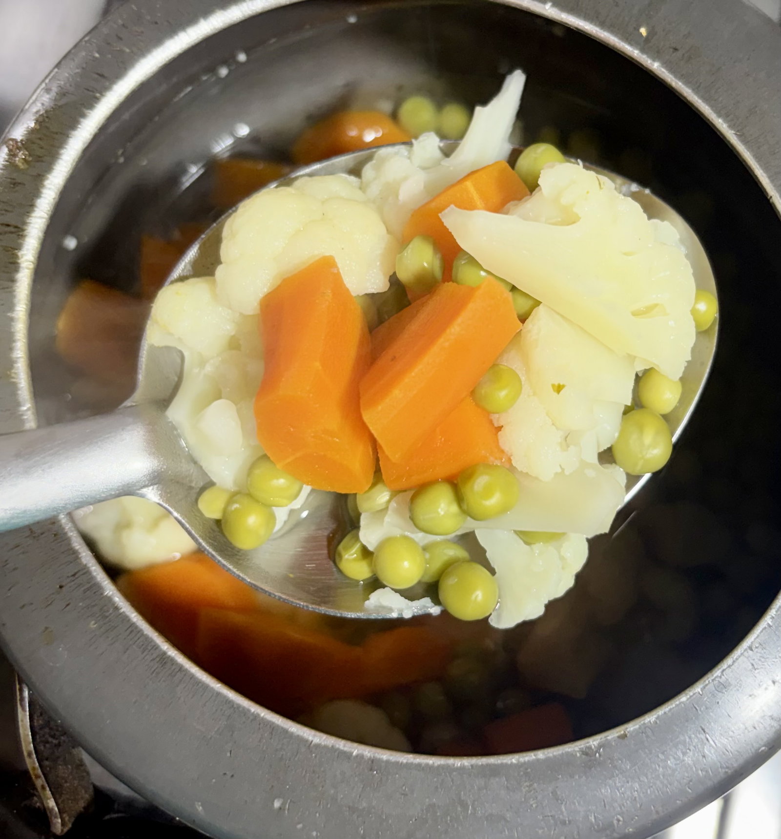 Step 1.1: In a pressure cooker, add green peas, cauliflower, and carrots with 1 cup of water