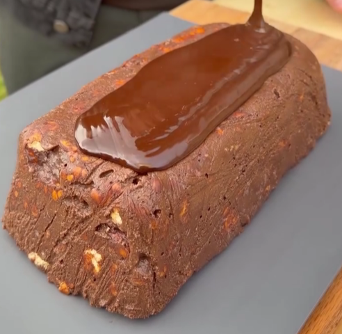 Step 1.1: Melt dark chocolate with heavy cream to make the ganache, pour over the chilled cake, and decorate with candied orange slices