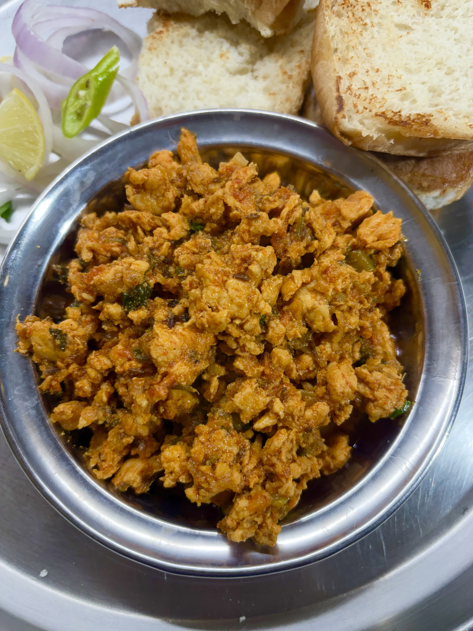 Step 6.1: Serve hot with lemon wedges and sliced red onions alongside pav, roti, naan, or rice
