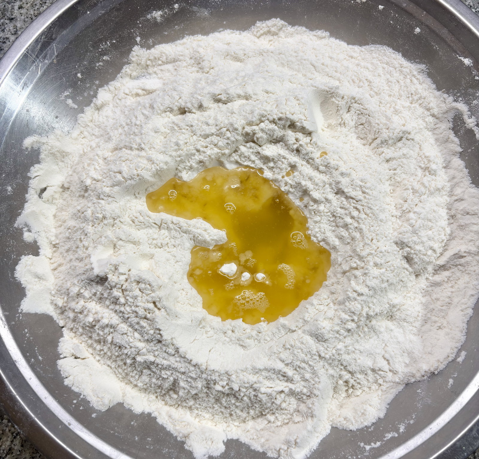 Step 2.1: Add ghee to the flour mixture and mix with light hands until it becomes crumbly