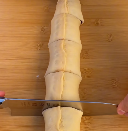 Step 3.1: Roll the dough tightly into a log and slice it into rolls