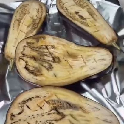 Step 1.1: Cut eggplants in half and make multiple holes with the knife