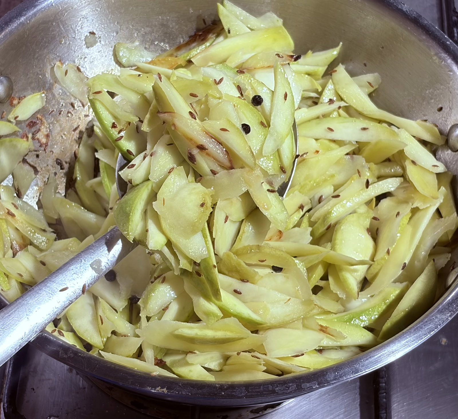 Step 2.2: Add the mangoes and stir for 4-5 minutes until they slightly change colour