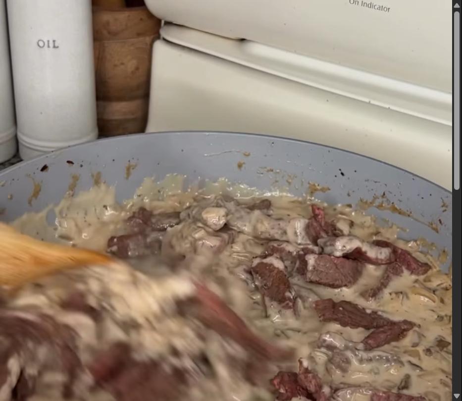 Step 1.1: Mix in sour cream until fully combined, then return the steak to the pan