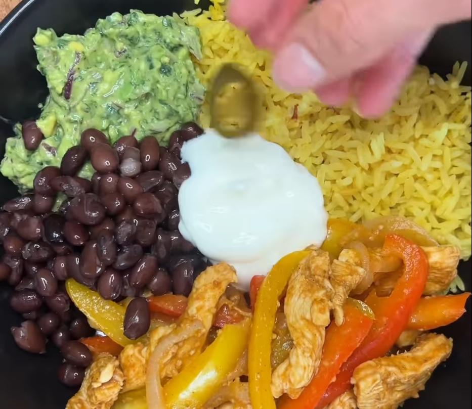 Step 5.1: Build the bowl with rice, sliced chicken, fajita veggies, black beans, and guacamole