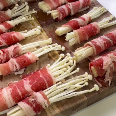 Step 1.1: Lay out the thin beef slices and place a small bundle of enoki mushrooms at one end