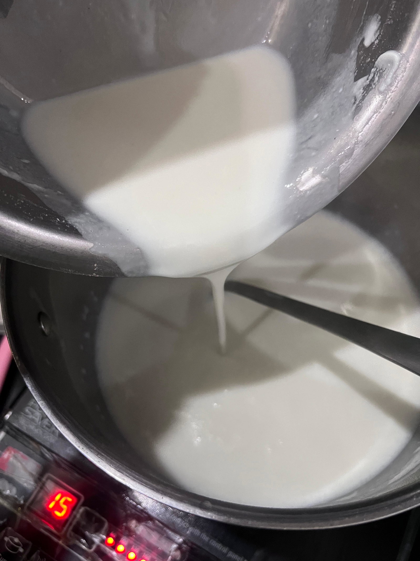 Step 1.1: Once the milk boils, lower the heat and slowly add the slurry, stirring continuously