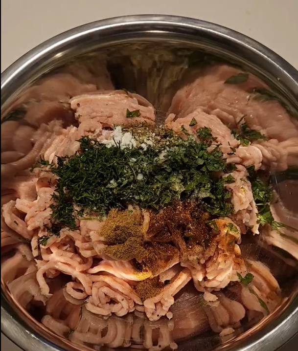 Step 1.1: Add chicken mince, chopped herbs, cumin powder, oregano, paprika, salt, pepper, garlic infused olive oil, lemon zest, and feta cheese into a bowl