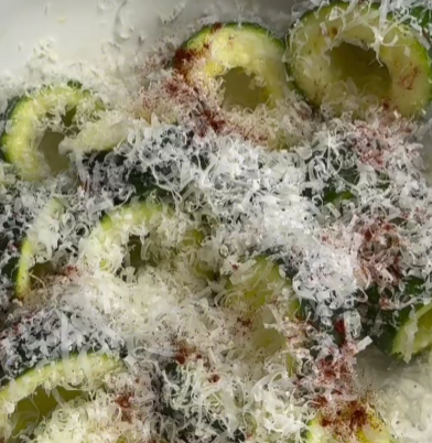 Step 1.1: Toss the zucchini rings in olive oil, then coat them with grated Parmesan and smoked paprika