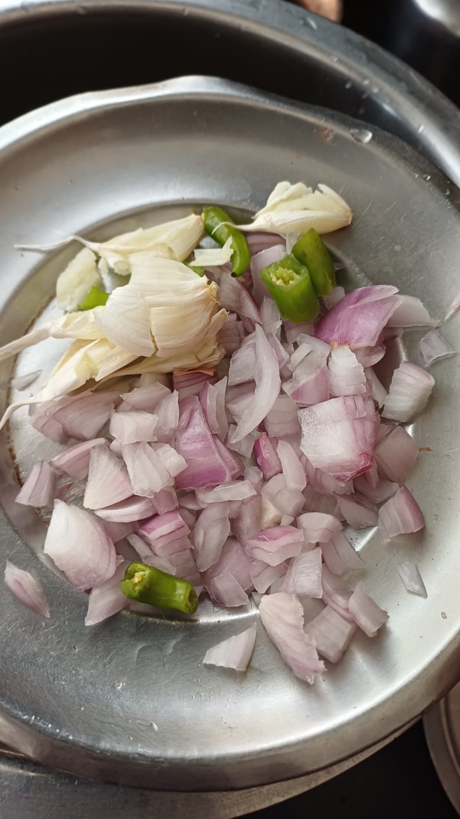 Step 1.1: Add chopped onion, green chillies, and garlic pods