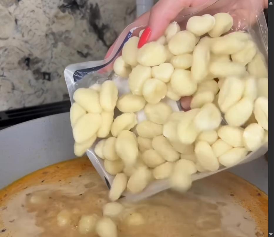 Step 2.1: Mix in the gnocchi, cover with a lid, lower the heat slightly, and simmer until the gnocchi is cooked through and the liquid has reduced and thickened
