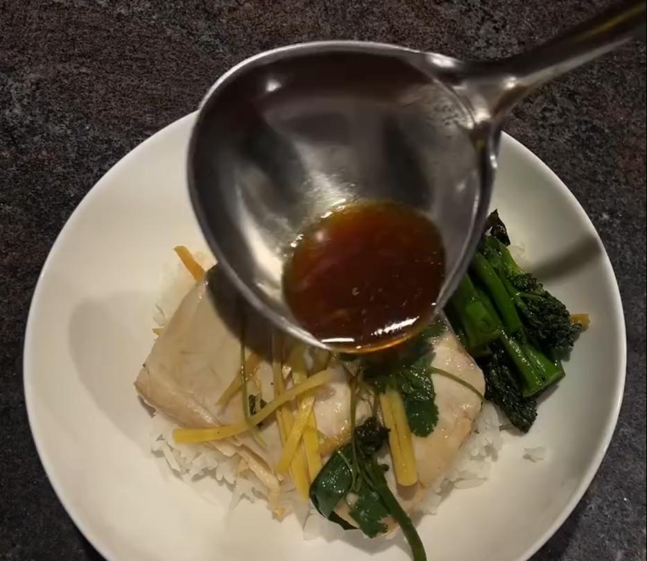 Step 5.1: Pour the remaining sauce over the steamed fish and top with fresh coriander and spring onion