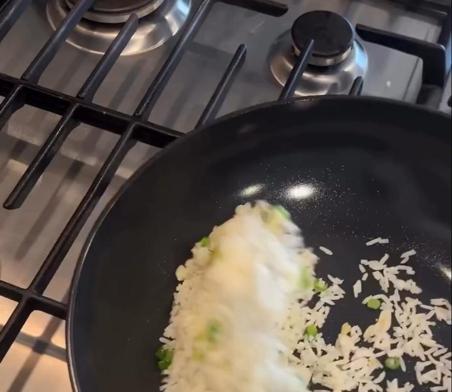 Step 1.1: Add the day-old rice, breaking up any clumps, and stir fry until the rice is heated and slightly crispy