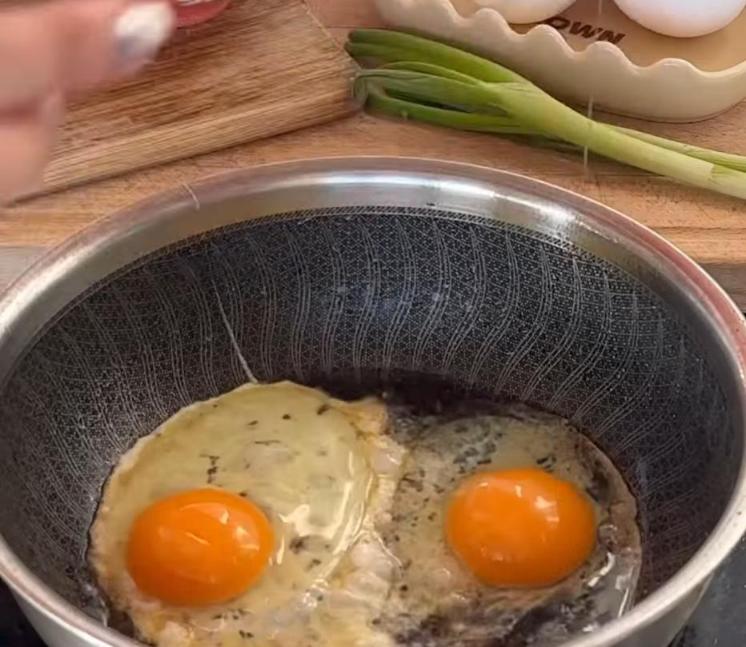 Step 1.1: Fry two eggs in the remaining oil, then remove from the pan