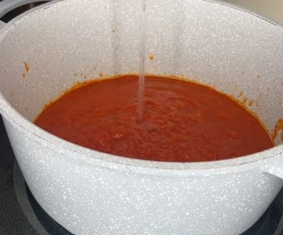 Step 2.1: Heat vodka sauce in a pan and stir in reserved pasta water, tortellini, and half & half until combined and creamy