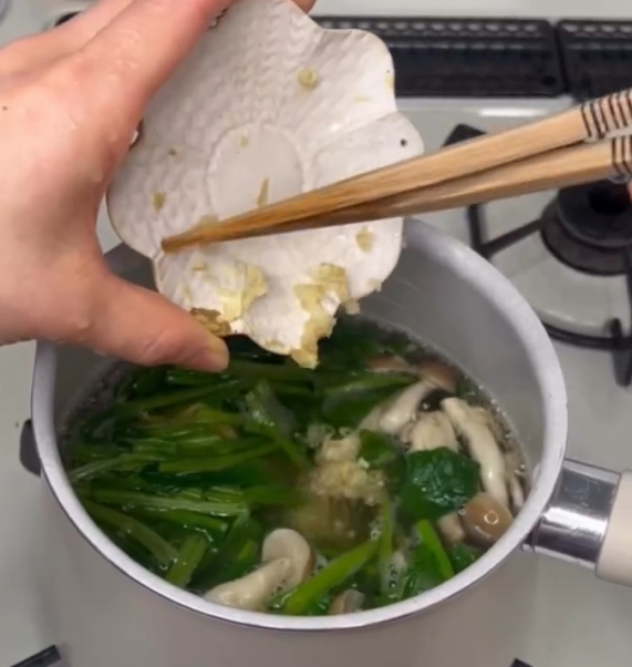 Step 1.1: Bring the dashi to a boil, then add the vegetables and grated ginger