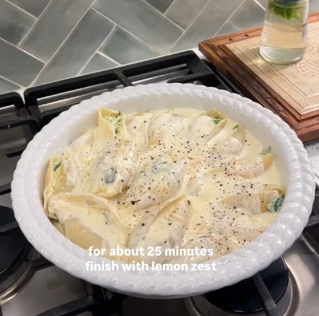 Step 4.1: Pour the lemon cream sauce over the stuffed shells, ensuring they are evenly coated