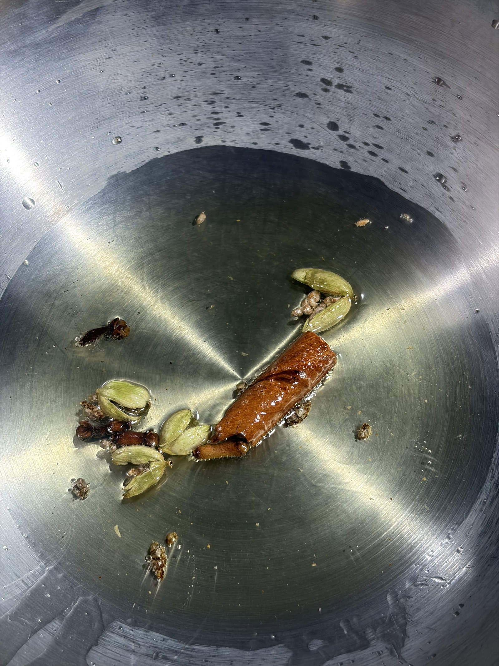 Step 3.1: Add green cardamoms, cinnamon, and cloves