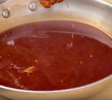 Step 4.1: Toss the chicken in hot honey glaze while still hot