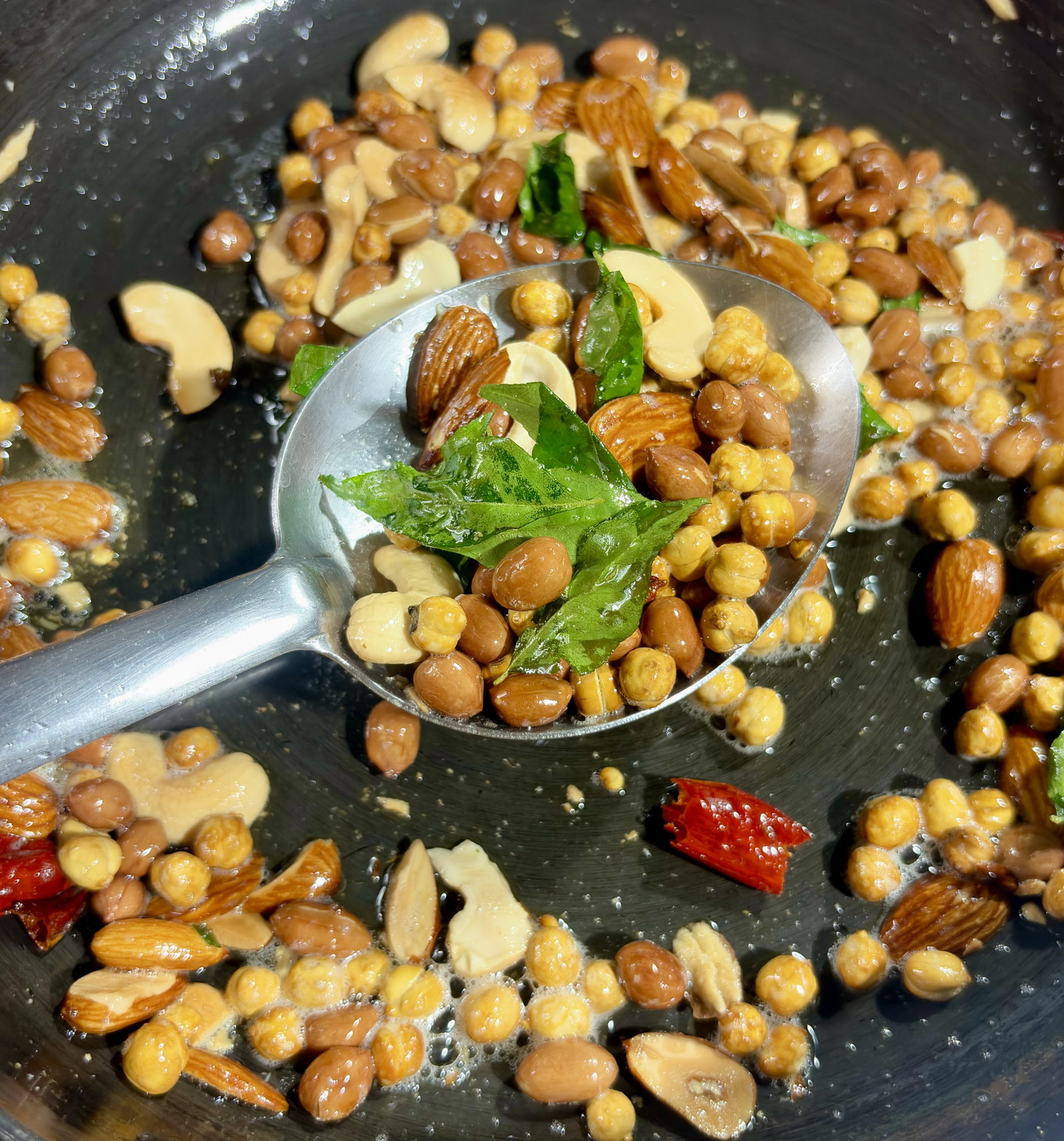 Step 2.1: Toss in the broken dry red chillies and fresh curry leaves