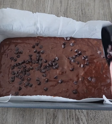 Step 1.1: Sprinkle the reserved choc chips and a pinch of salt on top of the batter